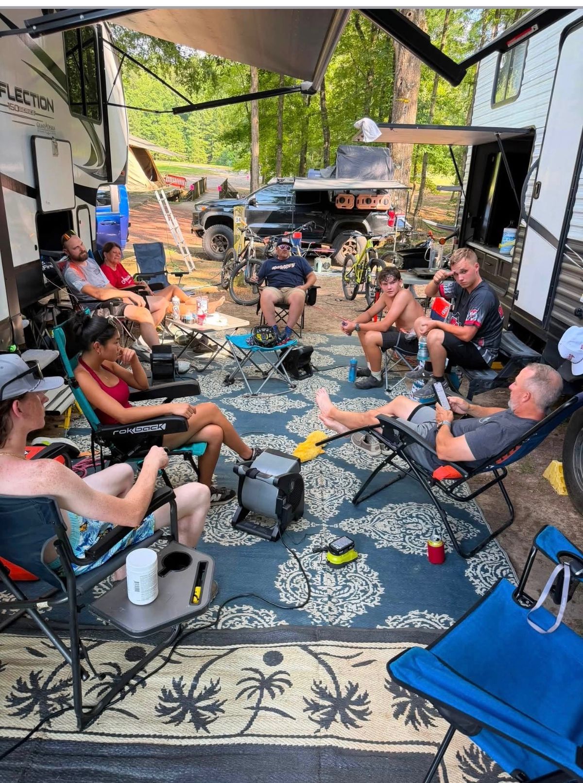 Friends and family gathered under the camper awning